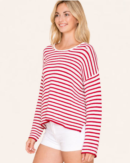 Woman wearing a red and white striped sweater on a beige background