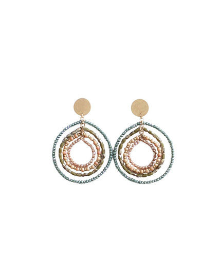 A pair of statement dangle earrings featuring multiple stacked concentric rings in textured rose gold, gold, and light blue metallic finishes, with round gold studs at the top, shown on a plain white background.