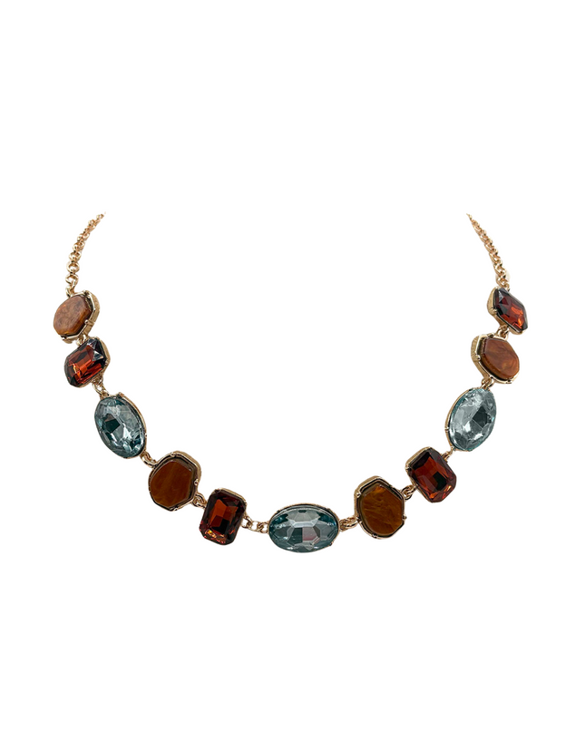 A gold-tone chain necklace featuring a series of oval and rectangular gemstone beads in shades of amber-brown, smoky red, and light blue, displayed on a clean white background.