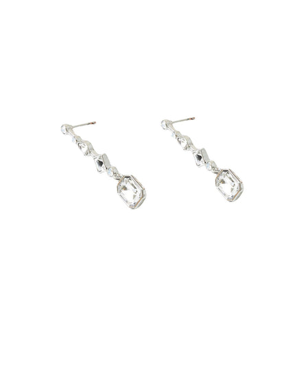 A pair of silver drop earrings with clear faceted gemstones, shown against a plain white background.