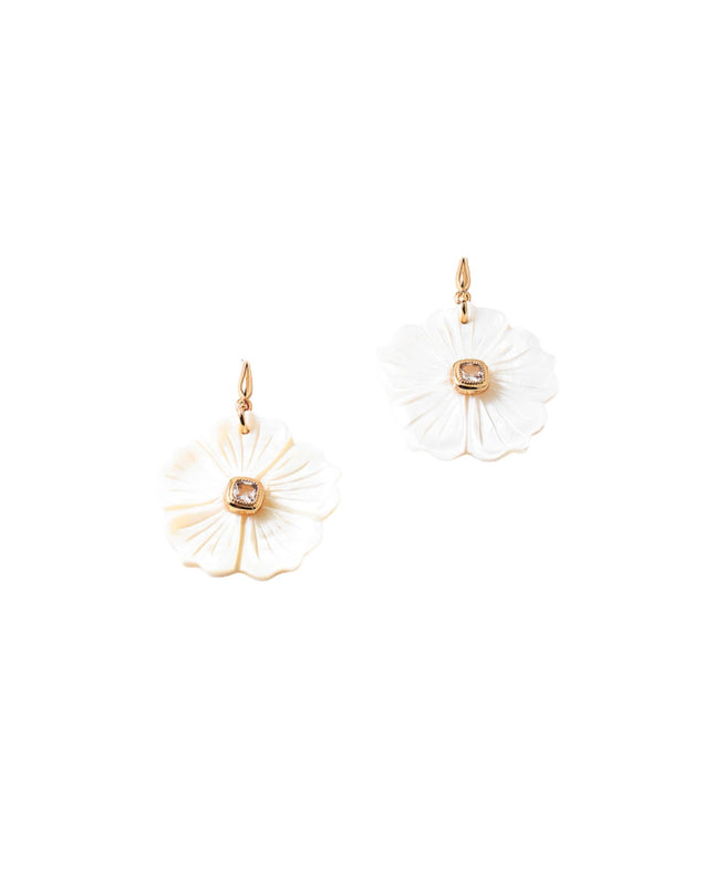 A pair of white flower-shaped drop earrings with gold-tone hooks and a small clear stone in the center, shown on a plain white background.