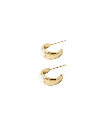 A pair of gold crescent-shaped hoop earrings with a white enamel inlay, shown from the side on a plain white background.