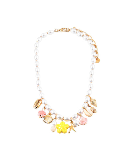 A gold-tone charm necklace featuring white faux pearls, seashell charms, a pink clam shell, a yellow flower charm, and a starfish charm, displayed on a solid white background.