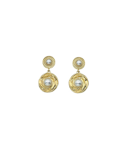 A pair of gold drop earrings with circular textured gold pendants featuring white pearl centers, set against a plain white background.