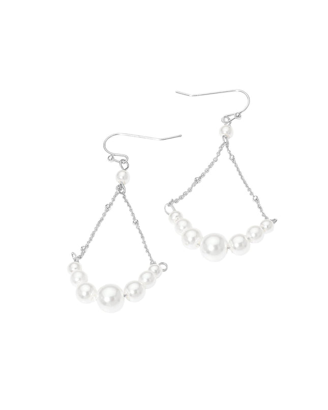 Pair of pearl drop earrings on a white background