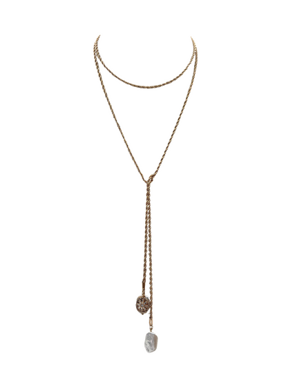 A gold-toned double-layered lariat necklace featuring a long dangle chain with a textured circular charm and a polished irregular stone pendant, displayed on a clean white background.