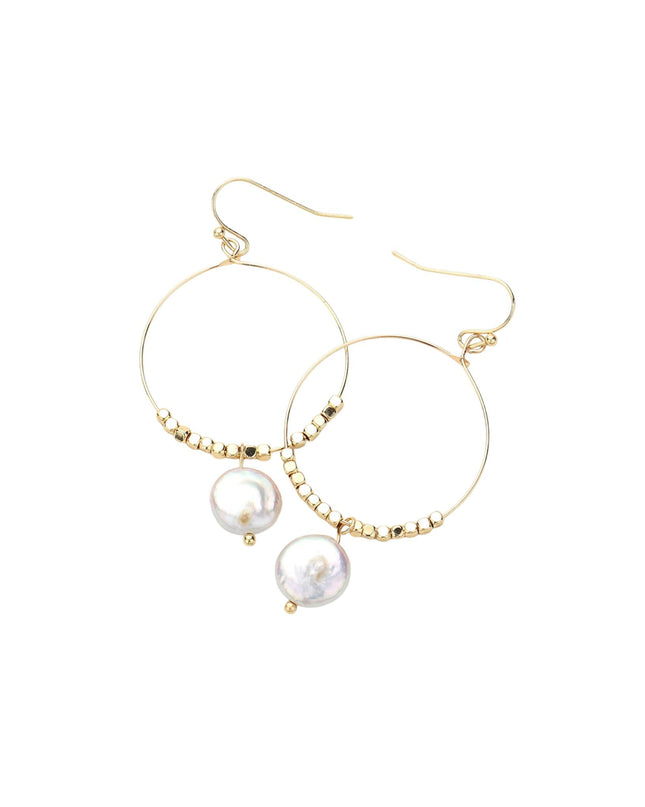 Gold hoop earrings with pearl drops on a white background