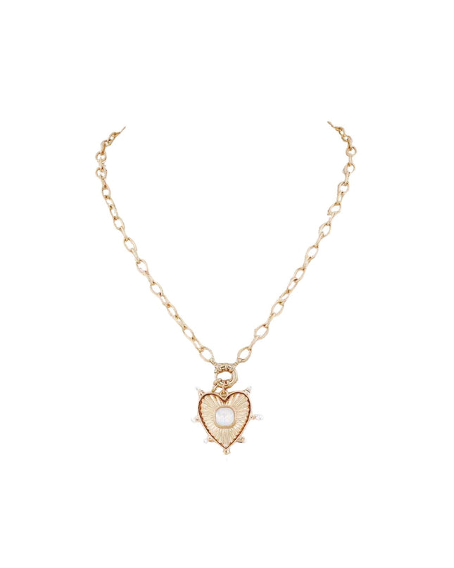A delicate gold chain necklace featuring a heart-shaped pendant with a central white pearl and small clear rhinestone accents, displayed on a clean white background.