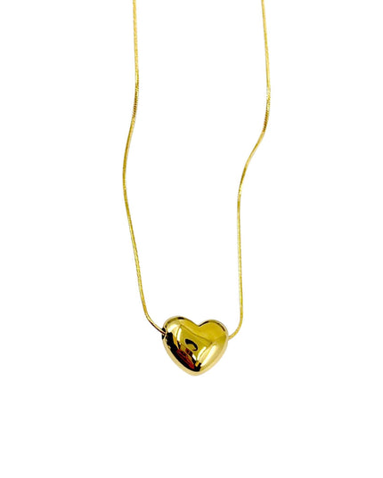 Gold heart-shaped pendant on a thin chain against a white background