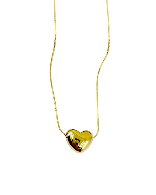 Gold heart-shaped pendant on a thin chain against a white background
