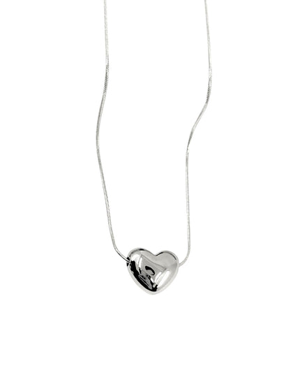 Silver heart-shaped pendant on a white chain against a white background