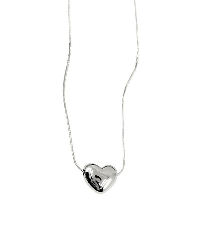 Silver heart-shaped pendant on a white chain against a white background