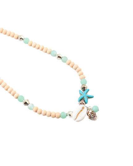 A beaded necklace featuring light wood beads, mint green beads, small silver spacer beads, and shell charms including a turquoise starfish, a white cowrie shell, and a brown seashell, displayed on a solid white background.