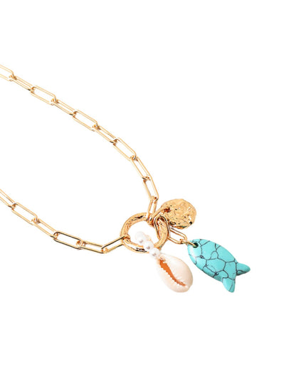 A gold paperclip chain necklace featuring three charms: a gold turtle charm, a white cowrie shell, and a small gold coin charm, displayed on a clean white background.