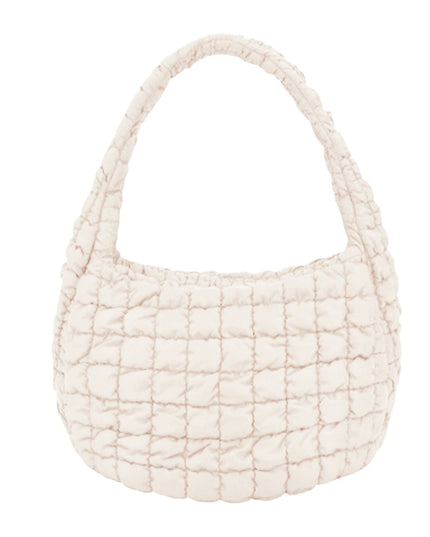 A cream-colored quilted shoulder bag with a single integrated strap, shown against a plain white background.