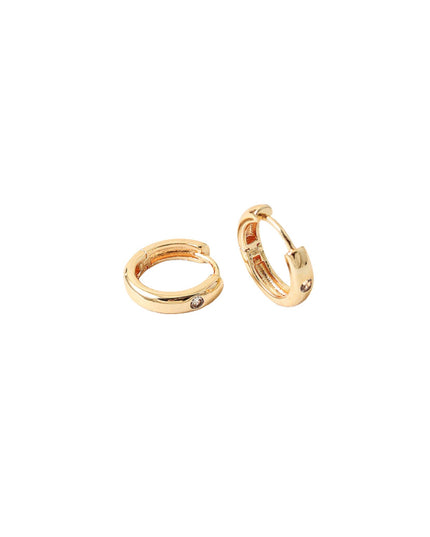 A pair of gold huggie hoop earrings with small inset clear stones, shown on a plain white background.