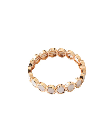 A rose gold stretch band bracelet featuring a row of oval white mother-of-pearl inlays, shown against a plain white background.