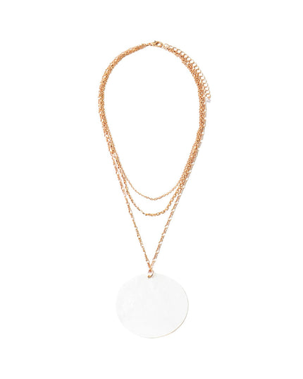 A rose gold layered necklace featuring three delicate chain layers and a large, flat circular disc pendant, displayed against a solid white background.