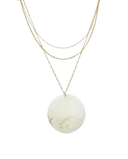 A gold layered necklace featuring a large, round, off-white stone pendant with subtle beige and light brown marbling, displayed against a solid white background.