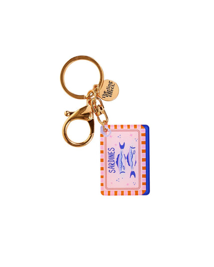 Keychain with a colorful label and gold clasp on a white background