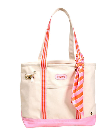 Beige tote bag with pink accents and a striped scarf on a white background
