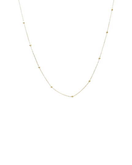 A delicate gold chain necklace featuring small, evenly spaced triangular bead accents, displayed against a solid white background.