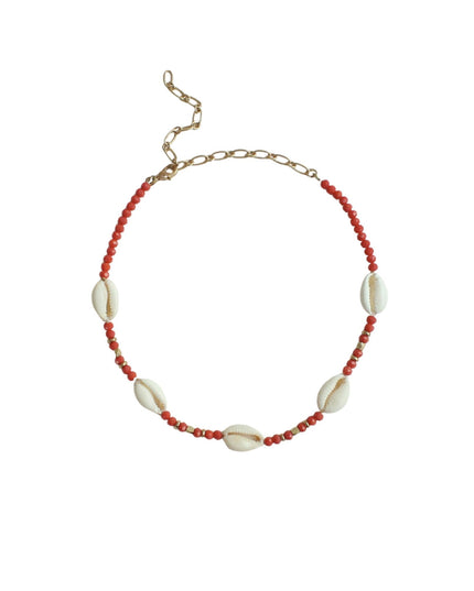 A beaded necklace featuring small red beads and five white cowrie shells, finished with a gold-tone chain extender clasp, shown on a plain white background.