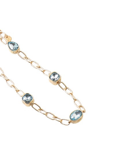 A gold chain necklace featuring five oval-cut light blue gemstones set in gold bezels, displayed on a clean white background.