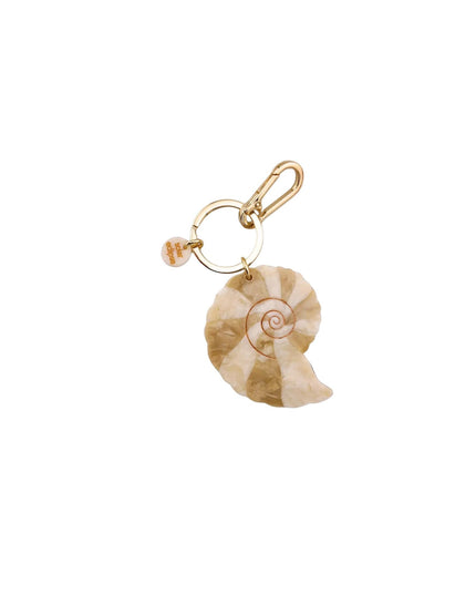 Gold brooch with a distinctive design on a white background