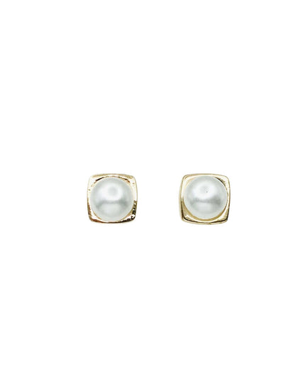 Pair of gold ball earrings on a white background