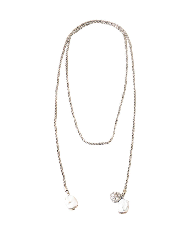 A silver-toned twisted rope chain necklace featuring two pendants: a larger irregular white shell-like charm and a smaller round clear stone charm, displayed against a solid white background.