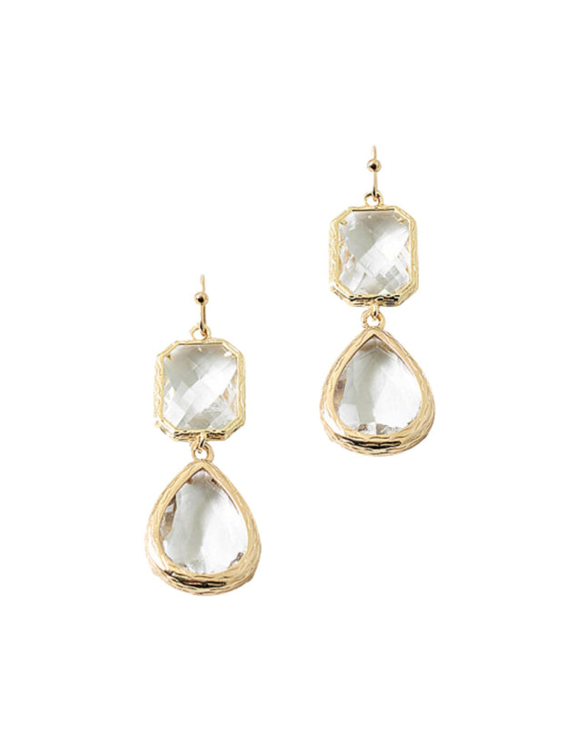 Gold earrings with clear gemstones on a white background