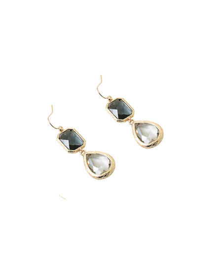 Pair of gold earrings with teardrop-shaped gemstones on a white background