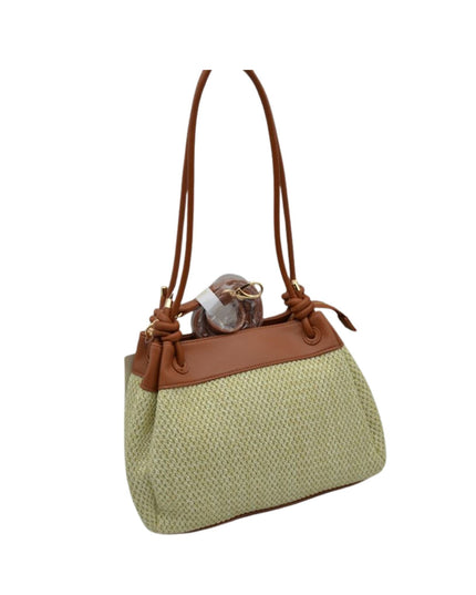 Green textured handbag with brown leather accents on a white background