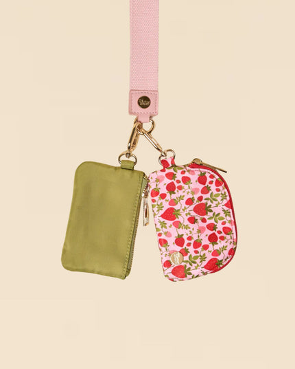Two small pouches, one green and one with a floral pattern, on a beige background.