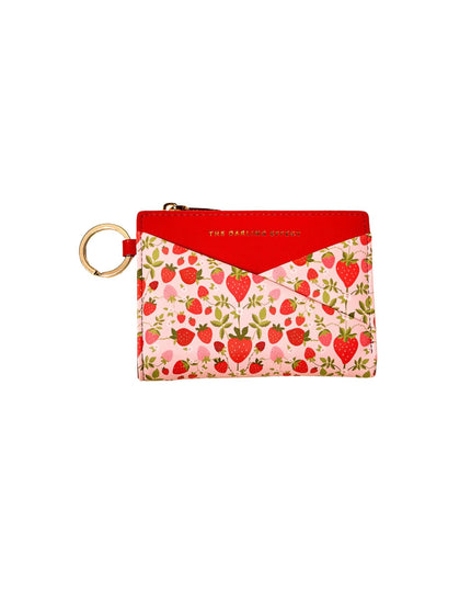 Small pouch with strawberry pattern and red top on a white background