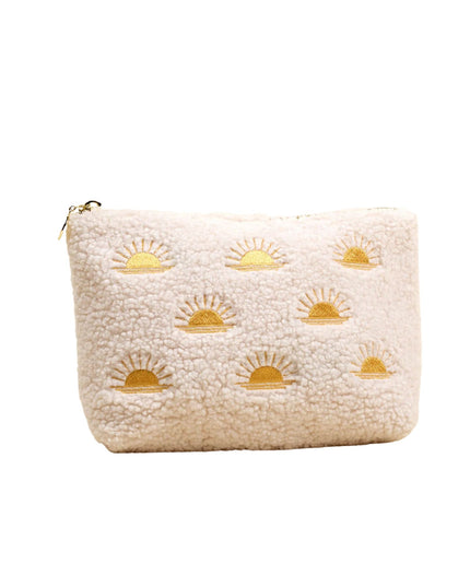 Beige pouch with gold sun patterns on a white background