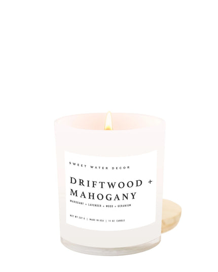Candle with 'Driftwood + Mahogany' label on a white background