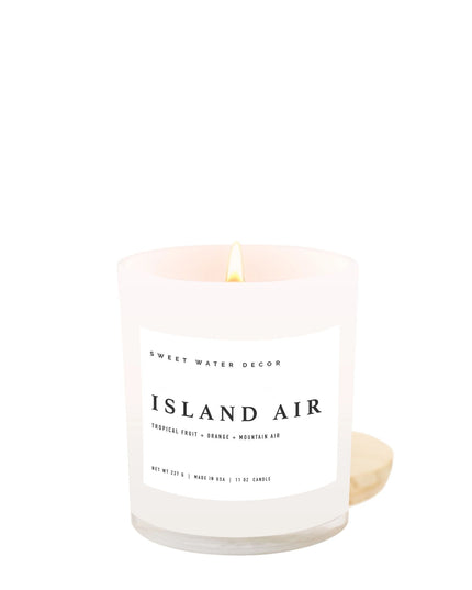 Candle labeled 'Island Air' by Sweet Water Decor on a white background