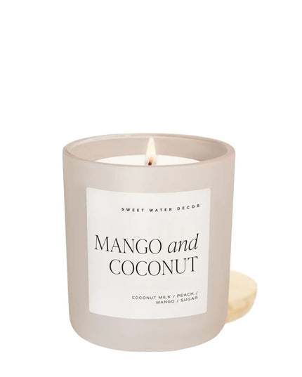 Candle with 'Mango and Coconut' label on a white background