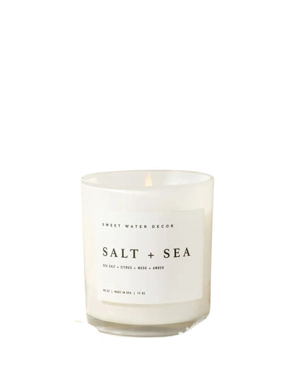 Candle labeled 'Salt + Sea' on a white background