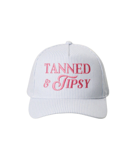 White cap with red text 'Tanned & Tipsy' on a white background