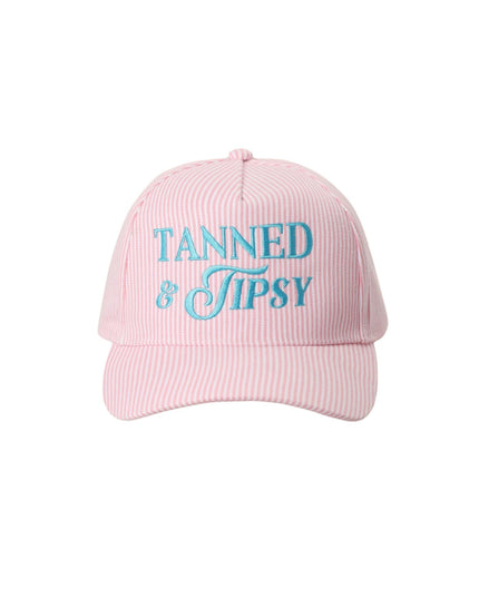 Pink cap with 'Tanned & Tipsy' text on a white background