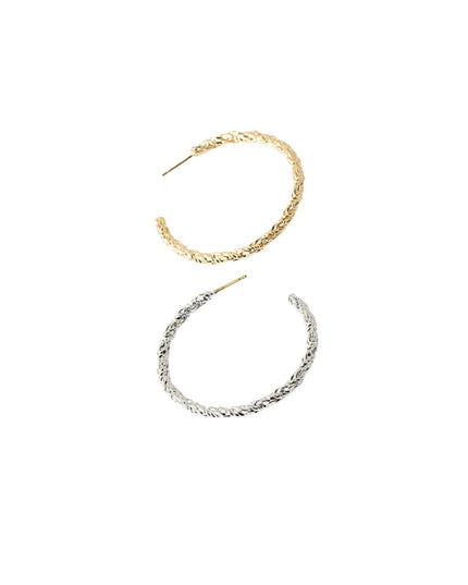 Two textured open hoop earrings, one in yellow gold and one in silver, displayed on a plain white background.
