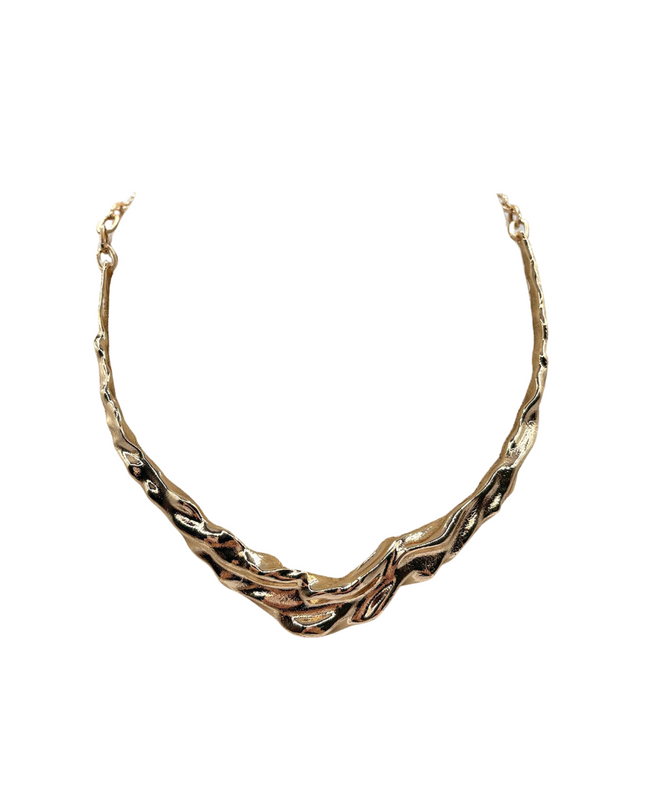 A textured, organic-shaped gold necklace with a twisted, wavy design, displayed on a solid white background.