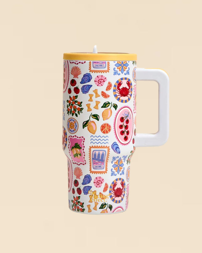 Colorful patterned tumbler with a handle on a beige background