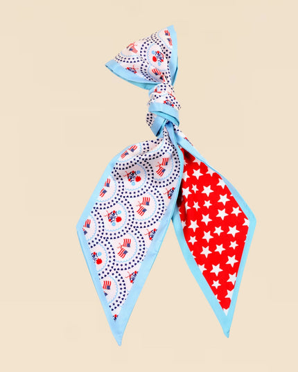 Two patterned scarves, one with a blue border and the other with red and white stars, on a beige background.