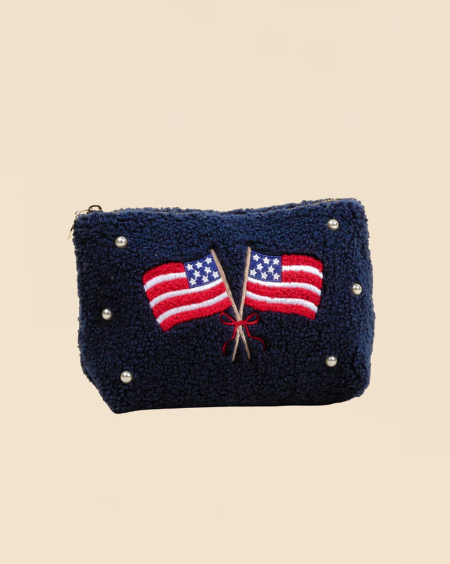 Navy blue pouch with American flags on a beige background