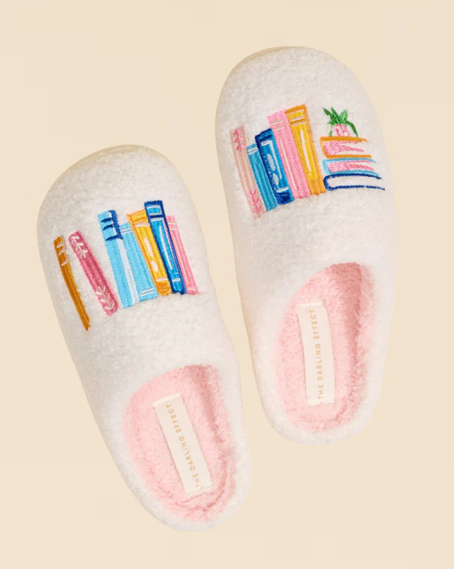 Pair of slippers with colorful book design on a beige background