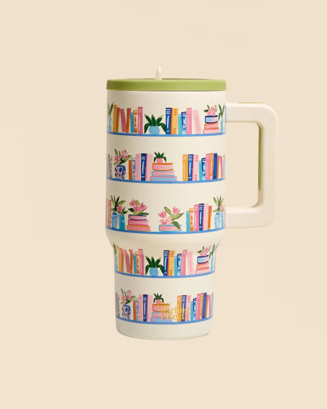 Tumbler with book-themed design on a beige background
